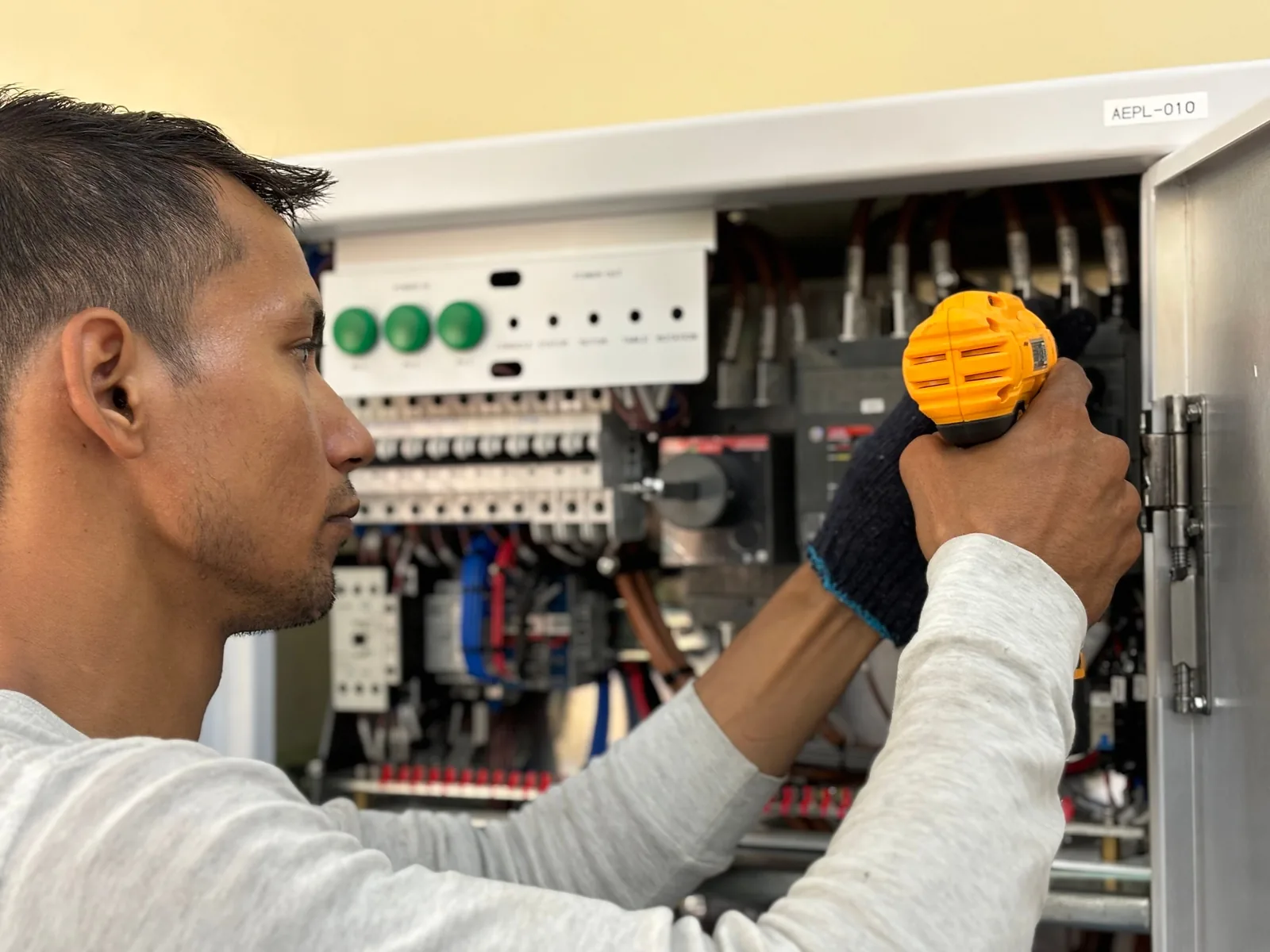 An electrician working on a commercial control panel, for panel upgrade in Abbotsford