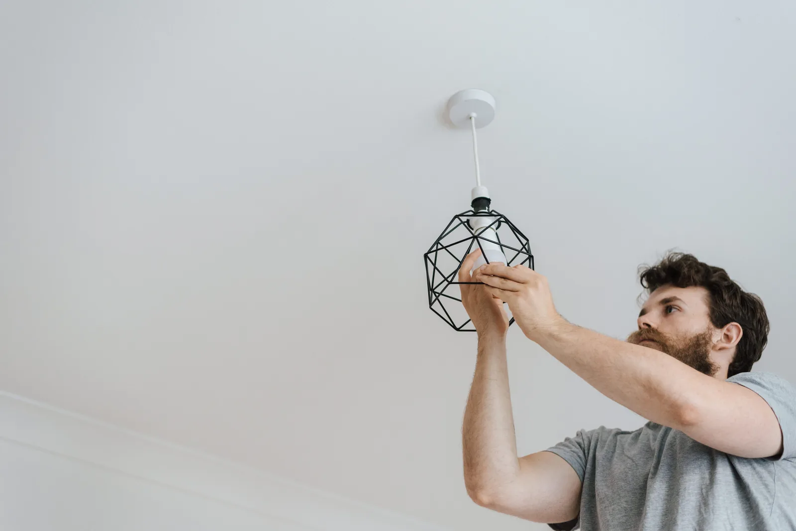 Fitting a lamp into a pendant fixture, for ev charger installation in Abbotsford